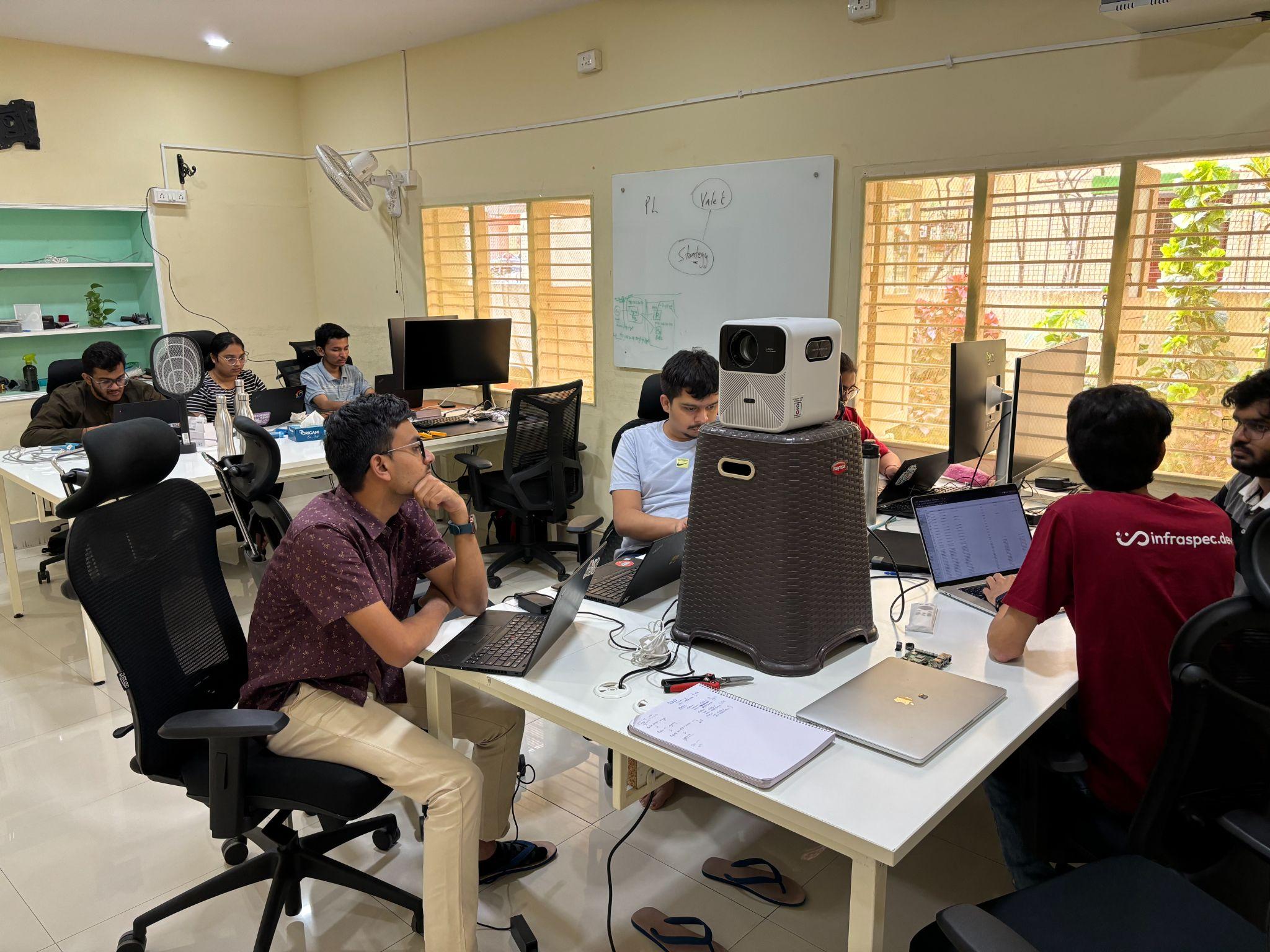 Infraspec team working around a shared desk